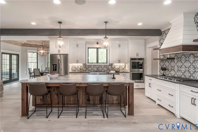 a living room with furniture a large window and a fireplace