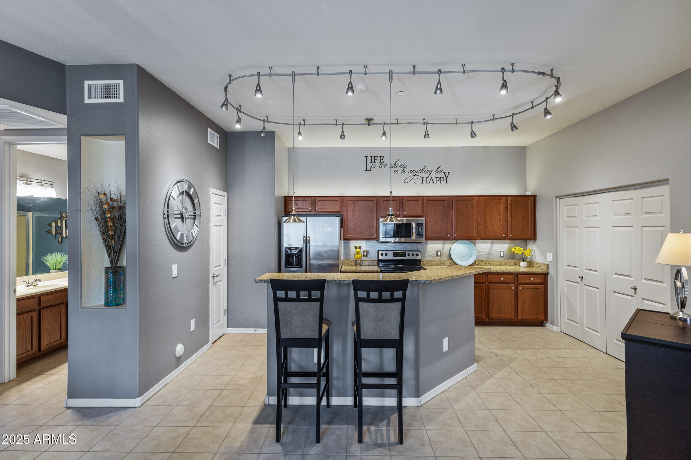a kitchen with a white cabinets and chairs