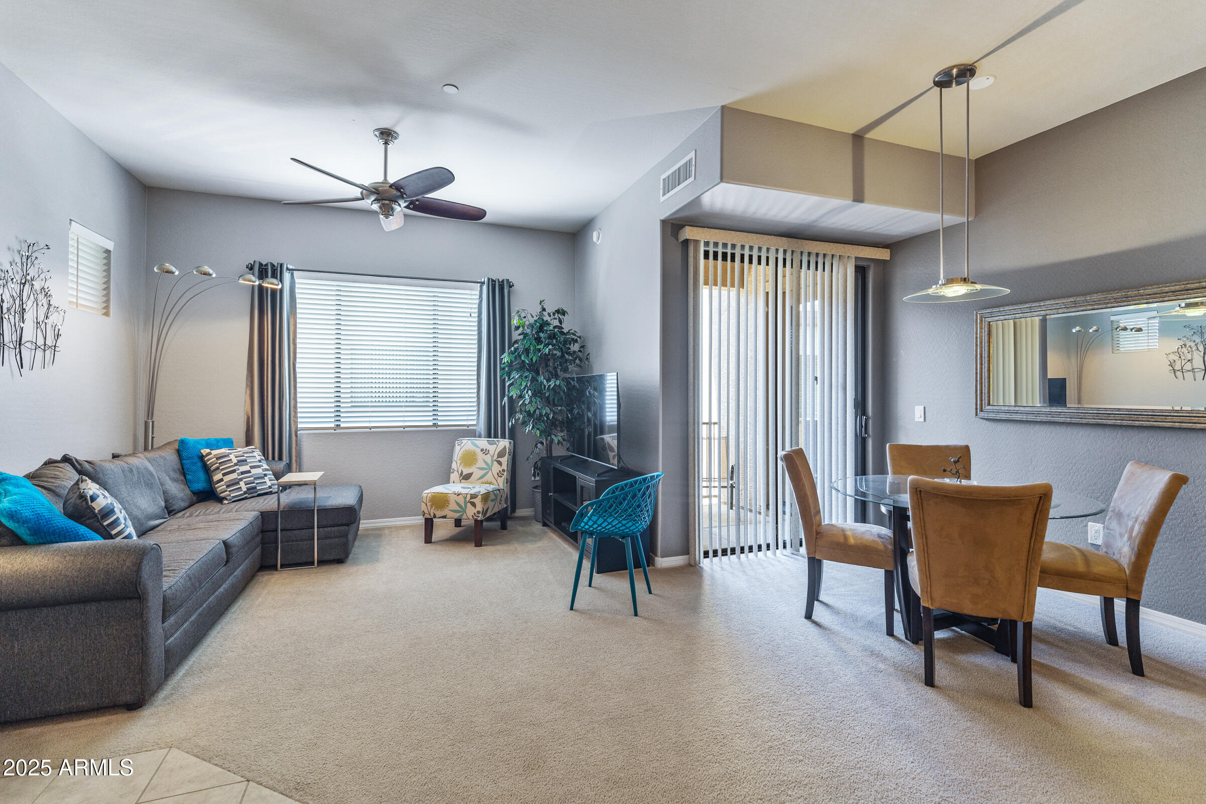 3330 South Gilbert Road, Unit 2013 Chandler, AZ 85286 - Photo 8 of 39 a living room with furniture and a chandelier