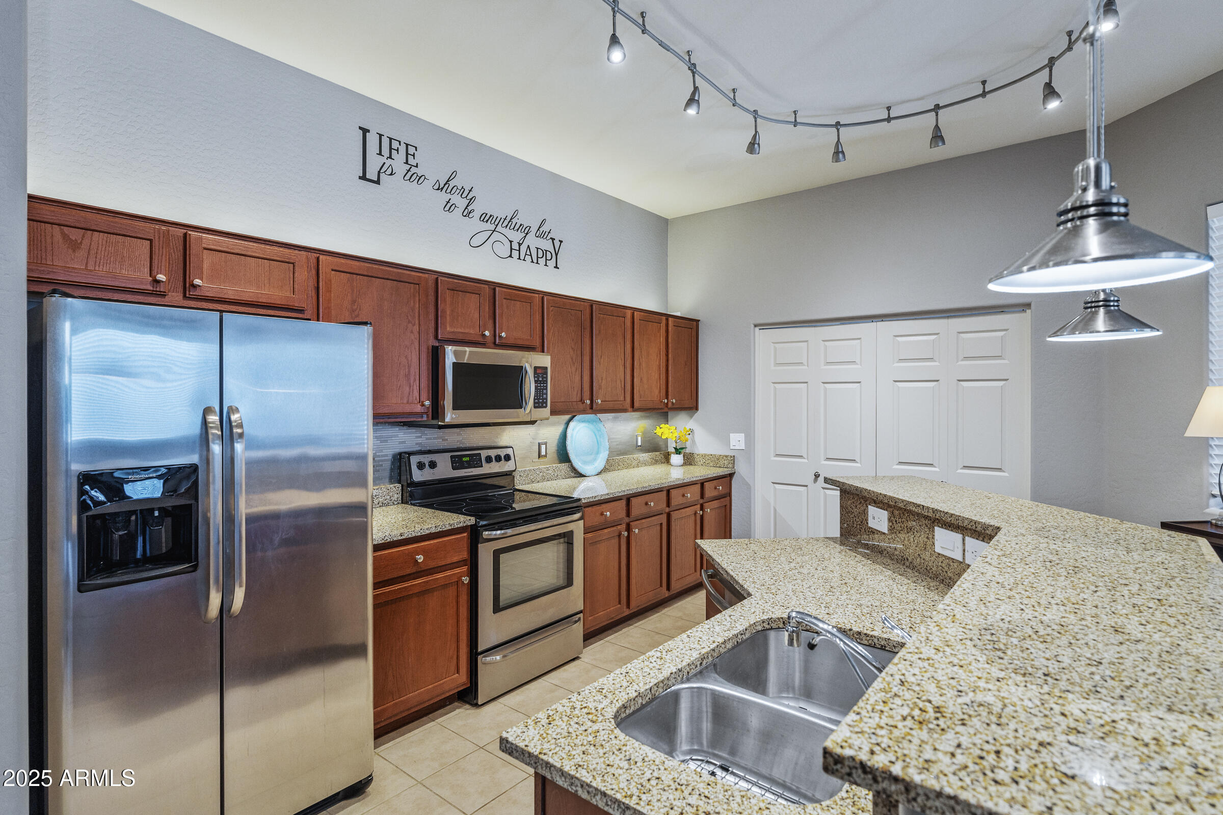 3330 South Gilbert Road, Unit 2013 Chandler, AZ 85286 - Photo 9 of 39 a kitchen with stainless steel appliances granite countertop a sink stove and refrigerator
