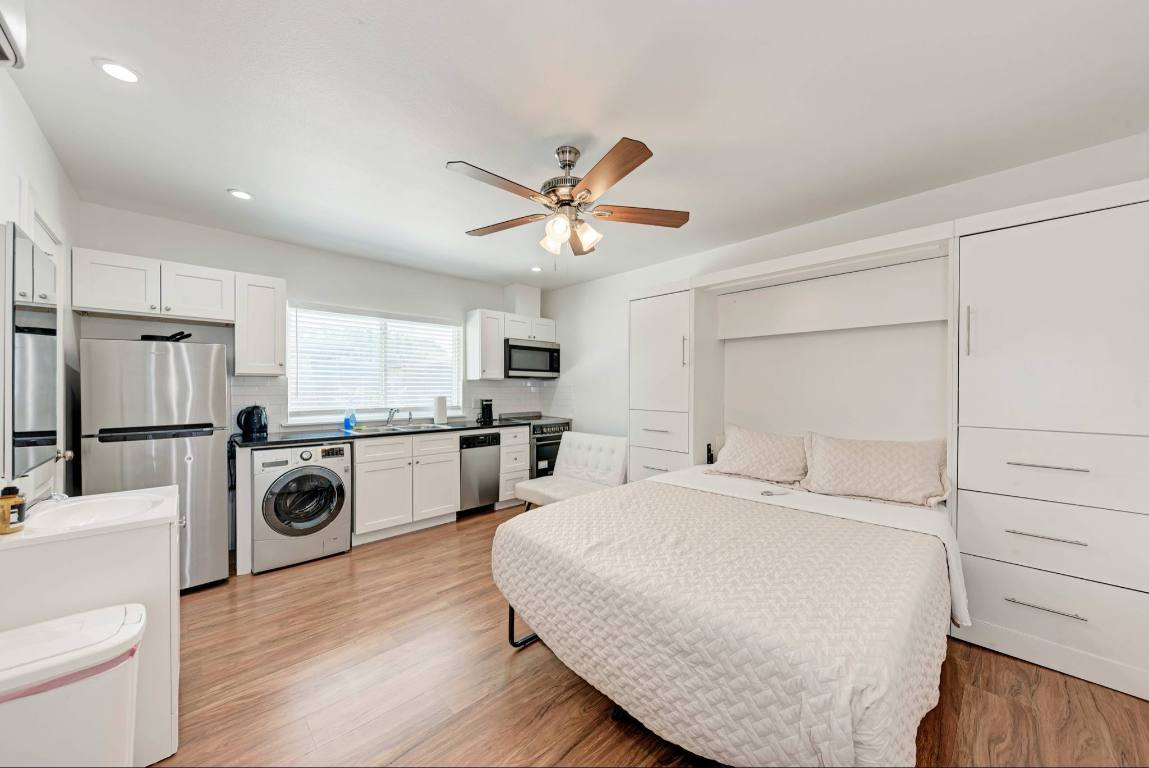 306 East 30th Street, Unit 102 Austin, TX 78705 - Photo 5 of 7 a view of a kitchen with sink refrigerator and cabinets