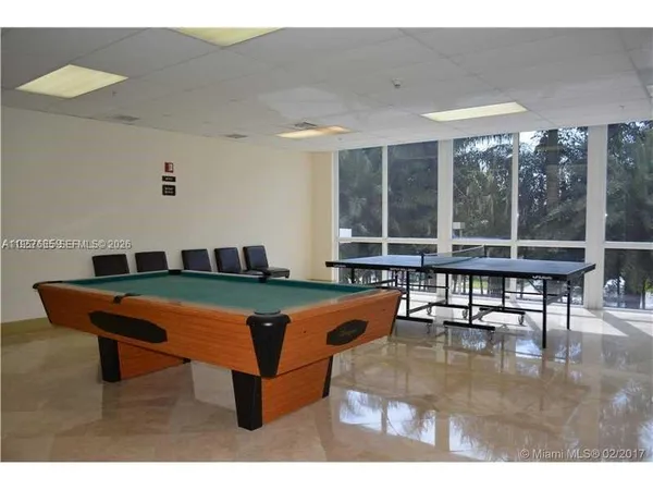 a living room with furniture a window and a table