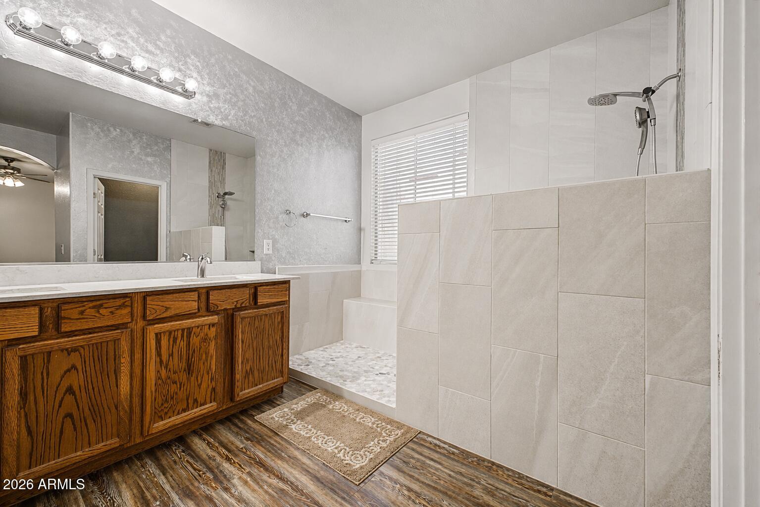 6622 West Harwell Road Laveen, AZ 85339 - Photo 19 of 32 a spacious bathroom with a double vanity sink and a mirror