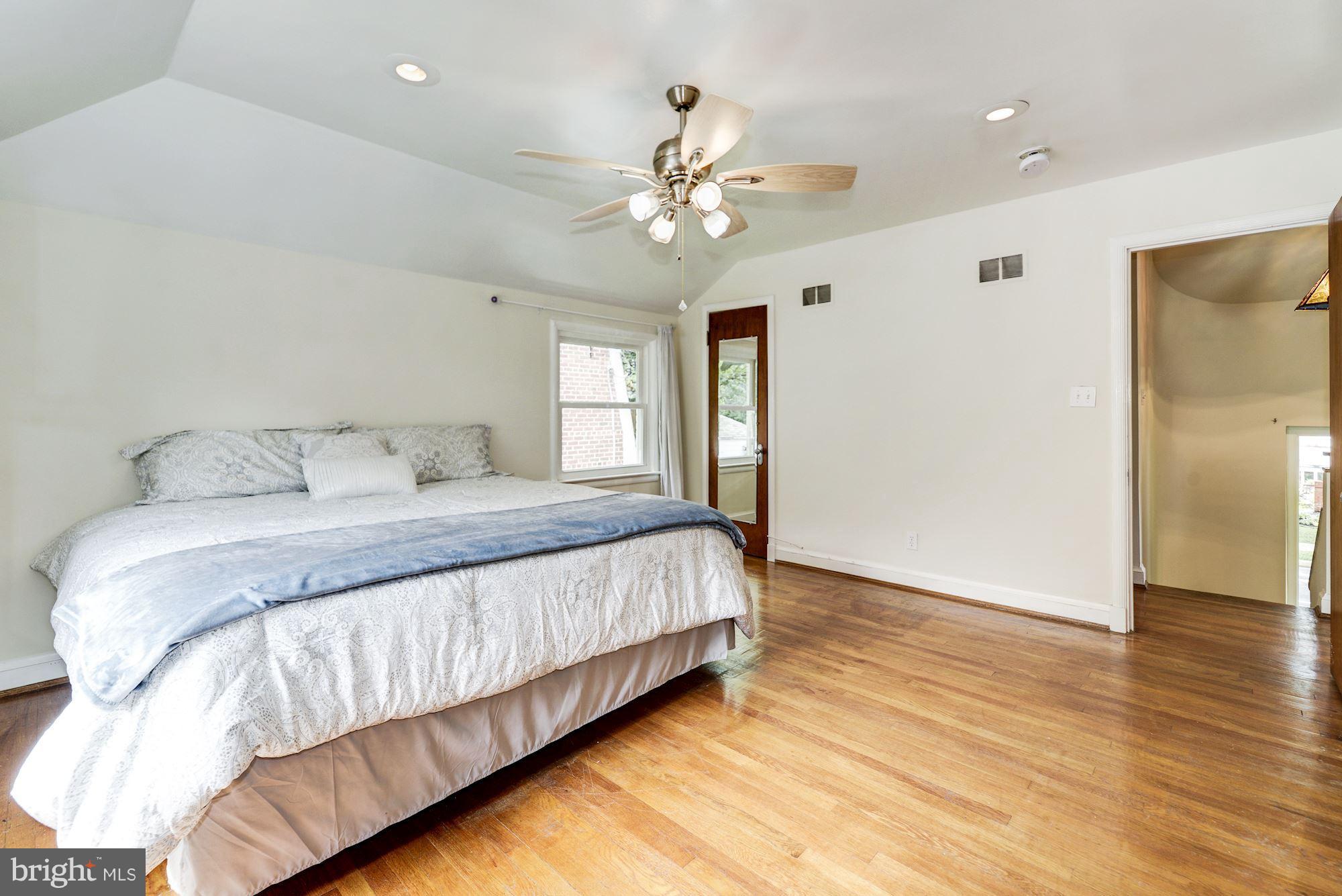 4300 Reno Road Northwest Washington, DC 20008 - Photo 12 of 22 a bedroom with a large bed chandelier and a window