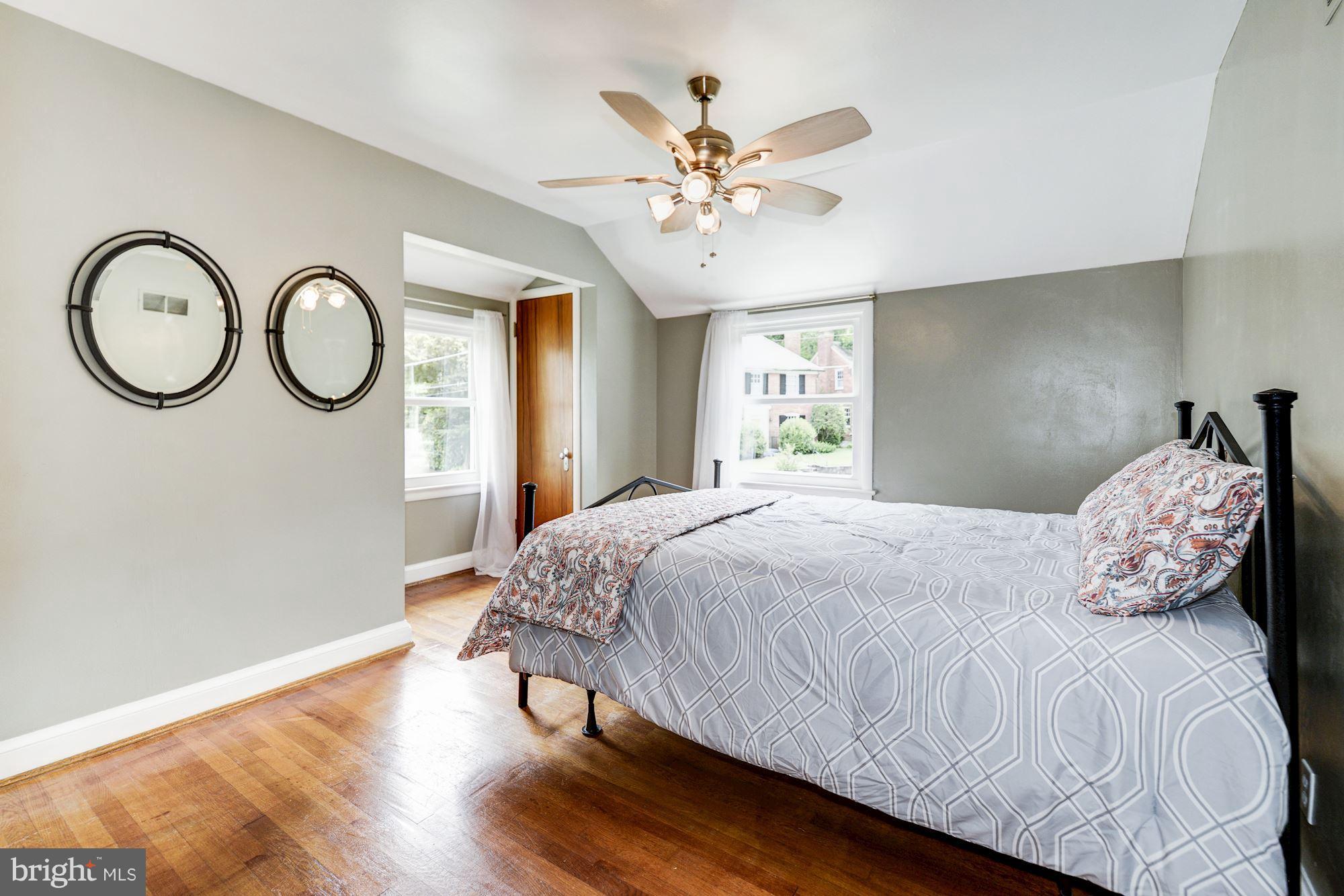 4300 Reno Road Northwest Washington, DC 20008 - Photo 13 of 22 a bedroom with a bed mirror and a window