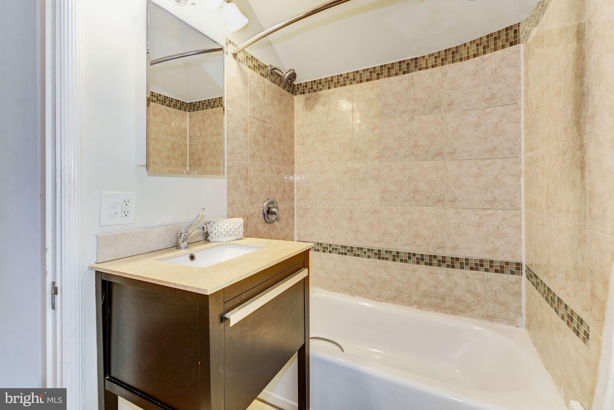 4300 Reno Road Northwest Washington, DC 20008 - Photo 15 of 22 a bathroom with a sink and a bathtub
