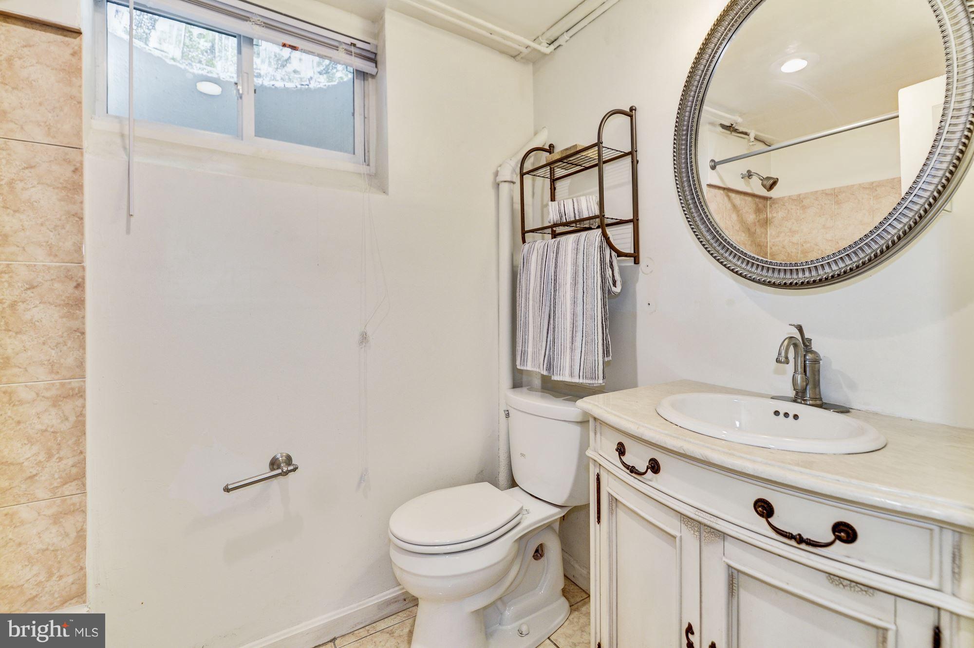 4300 Reno Road Northwest Washington, DC 20008 - Photo 18 of 22 a bathroom with a sink a toilet and a mirror
