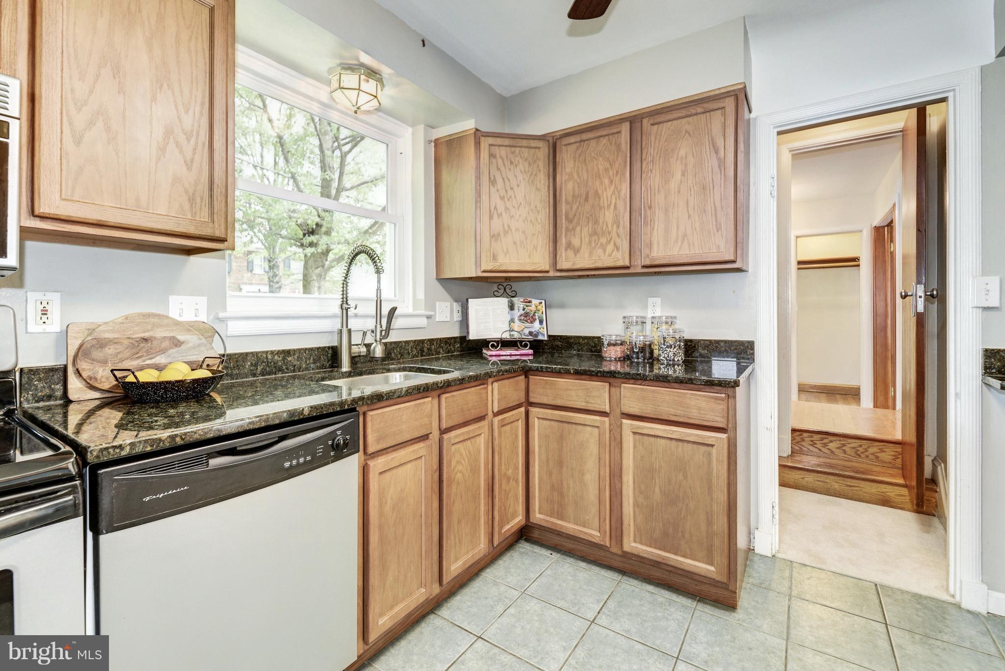 4300 Reno Road Northwest Washington, DC 20008 - Photo 7 of 22 a kitchen with stainless steel appliances granite countertop a sink stove and cabinets