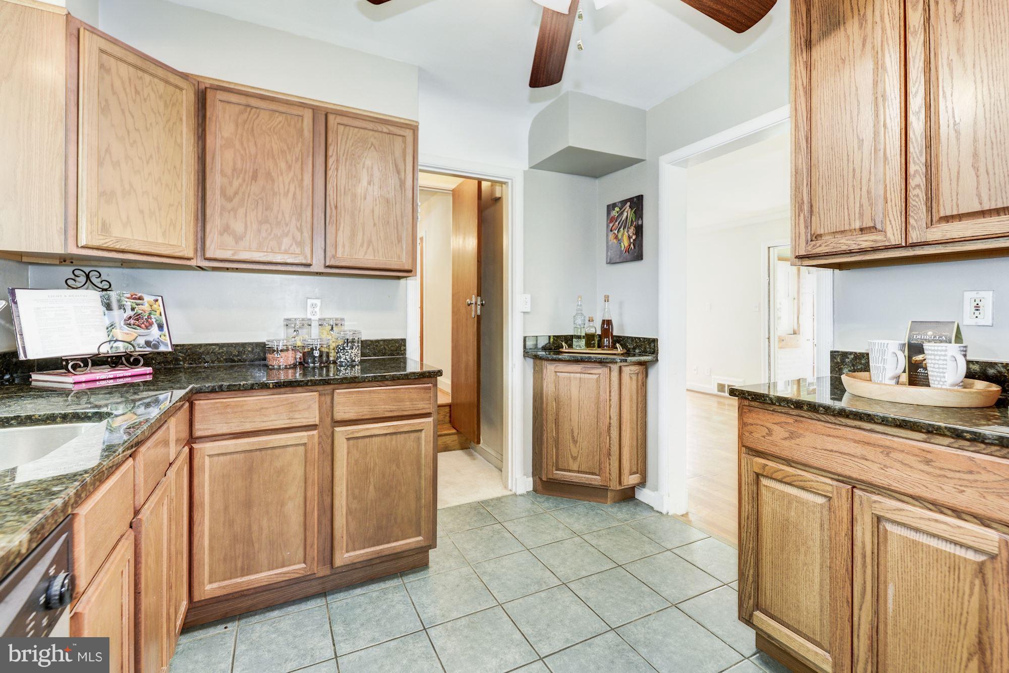 4300 Reno Road Northwest Washington, DC 20008 - Photo 8 of 22 a kitchen with stainless steel appliances granite countertop a refrigerator sink and cabinets