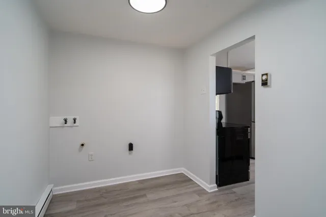 a kitchen with stainless steel appliances a stove a sink cabinets and a wooden floor