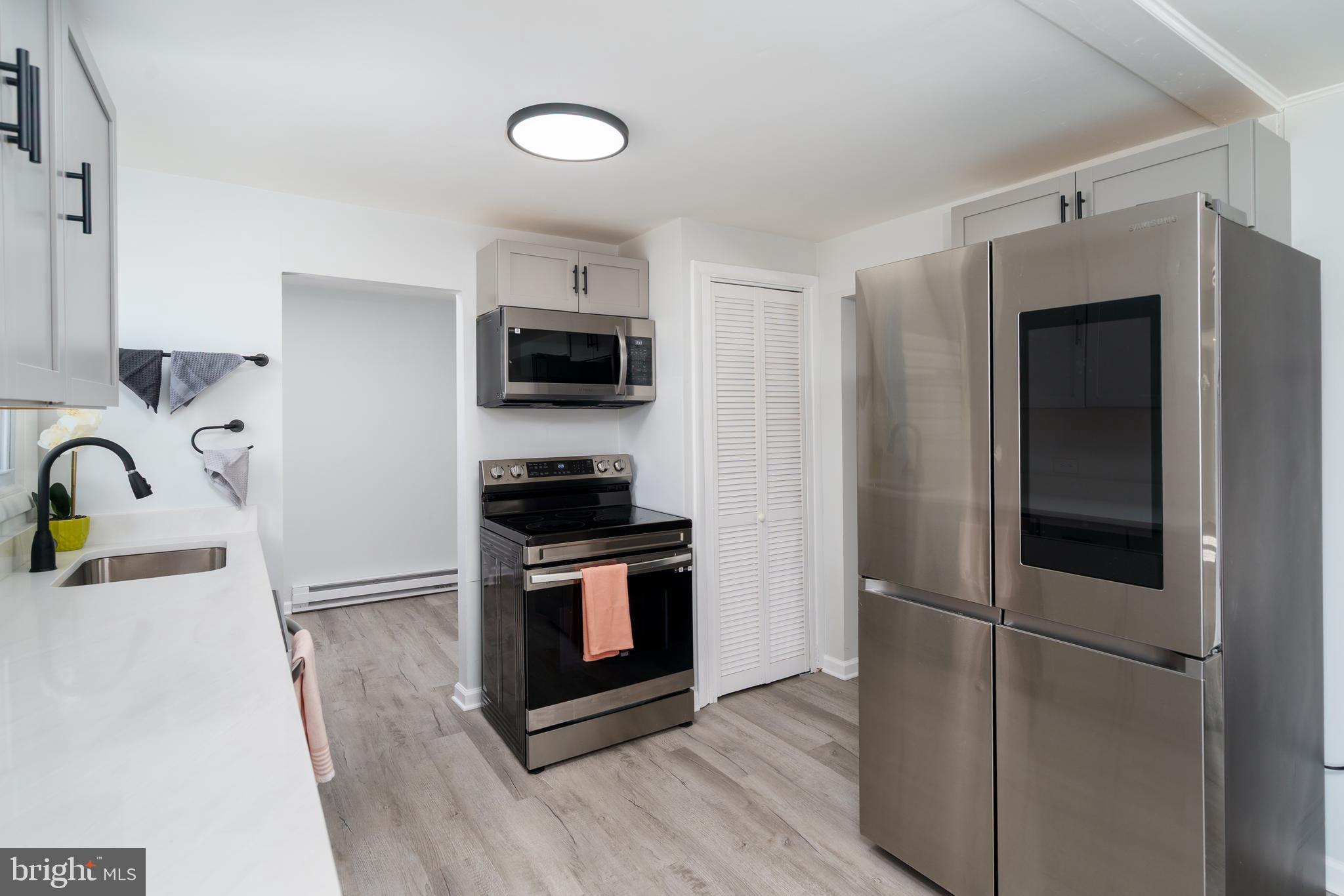 5781 Timber Ridge Road Berkeley Springs, WV 25411 - Photo 14 of 25 a kitchen with stainless steel appliances granite countertop a refrigerator stove and sink