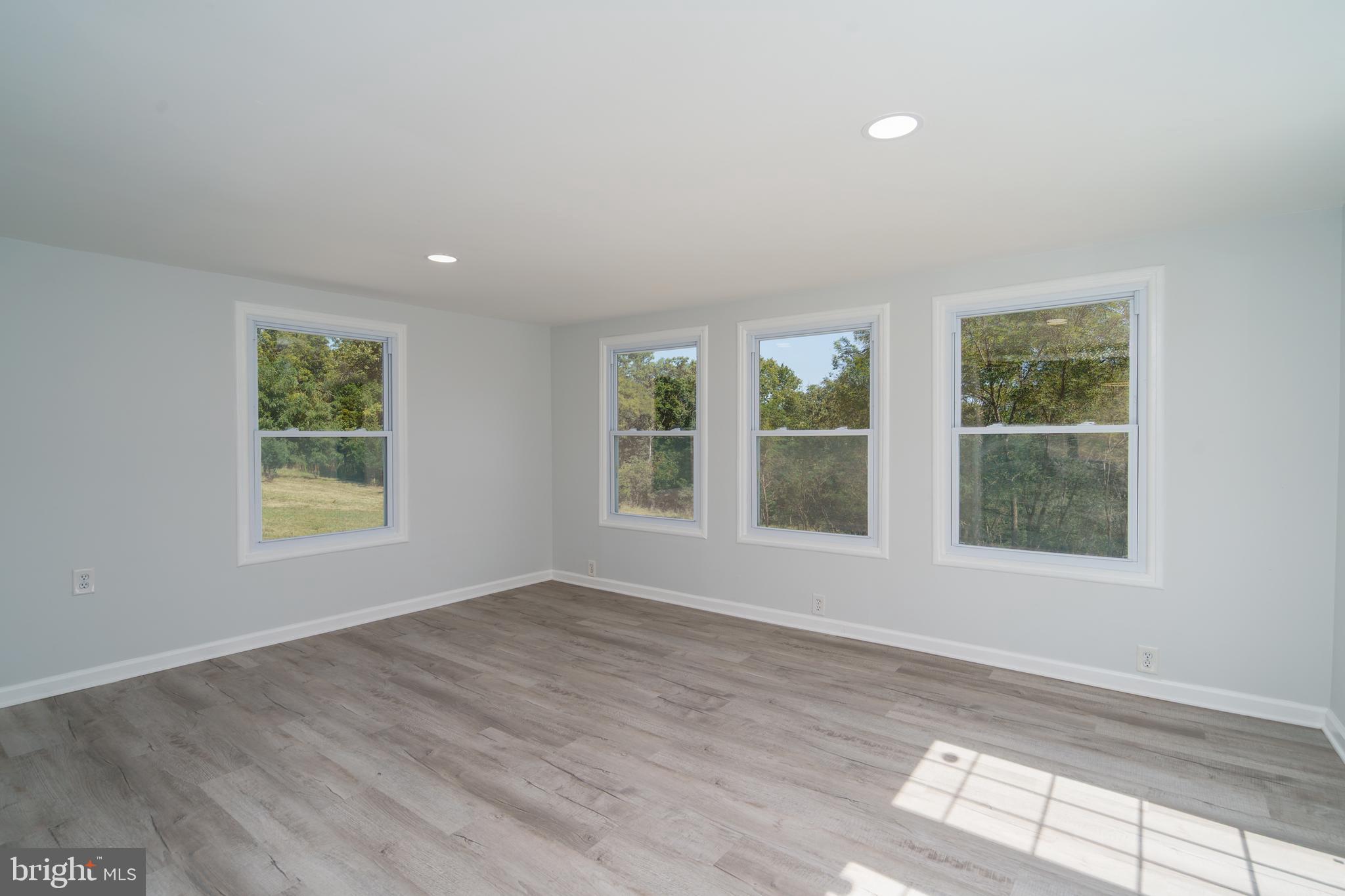 5781 Timber Ridge Road Berkeley Springs, WV 25411 - Photo 16 of 25 a view of an empty room with a window and wooden floor