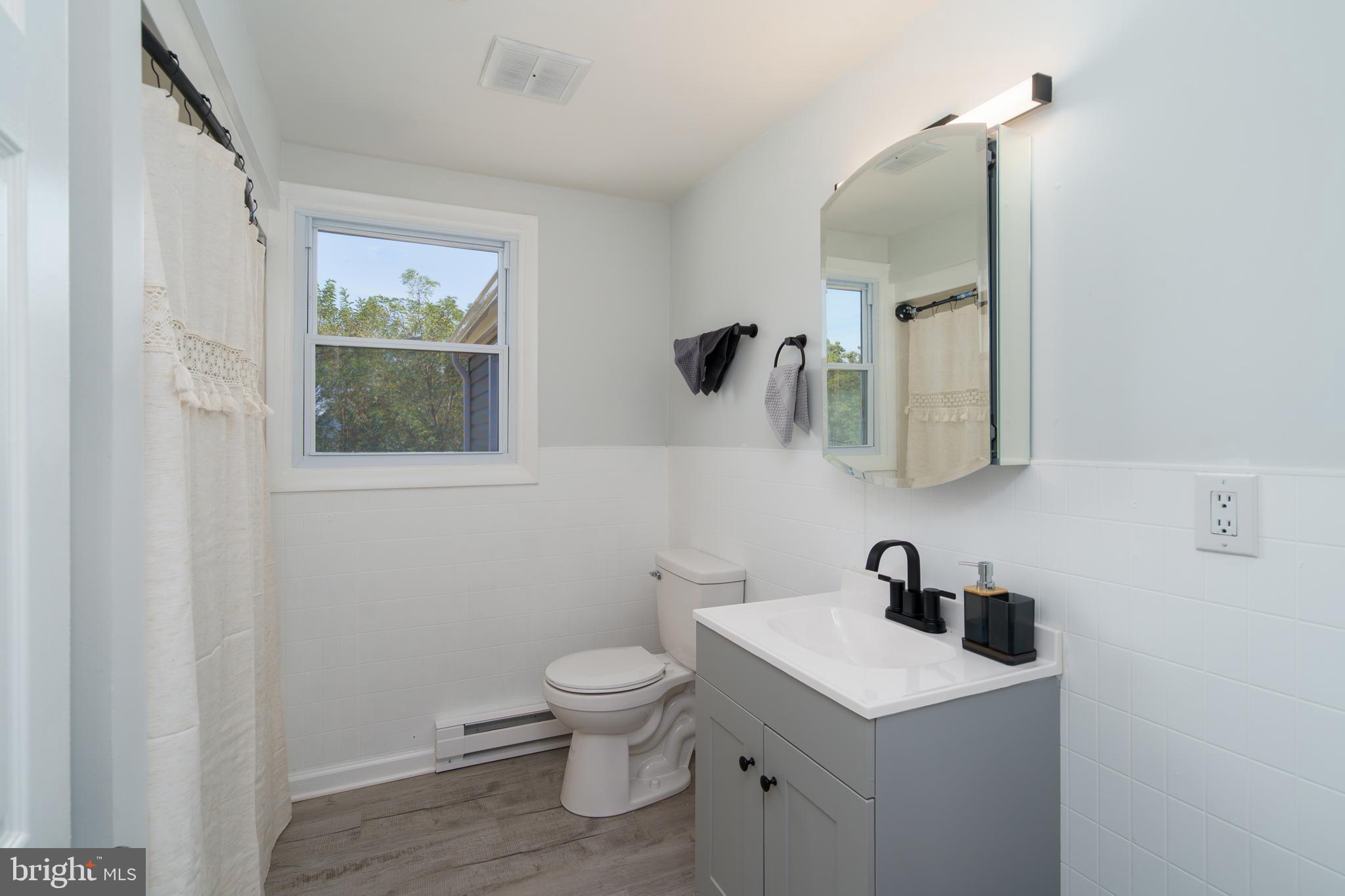 5781 Timber Ridge Road Berkeley Springs, WV 25411 - Photo 20 of 25 a white toilet sitting next to a bathroom sink