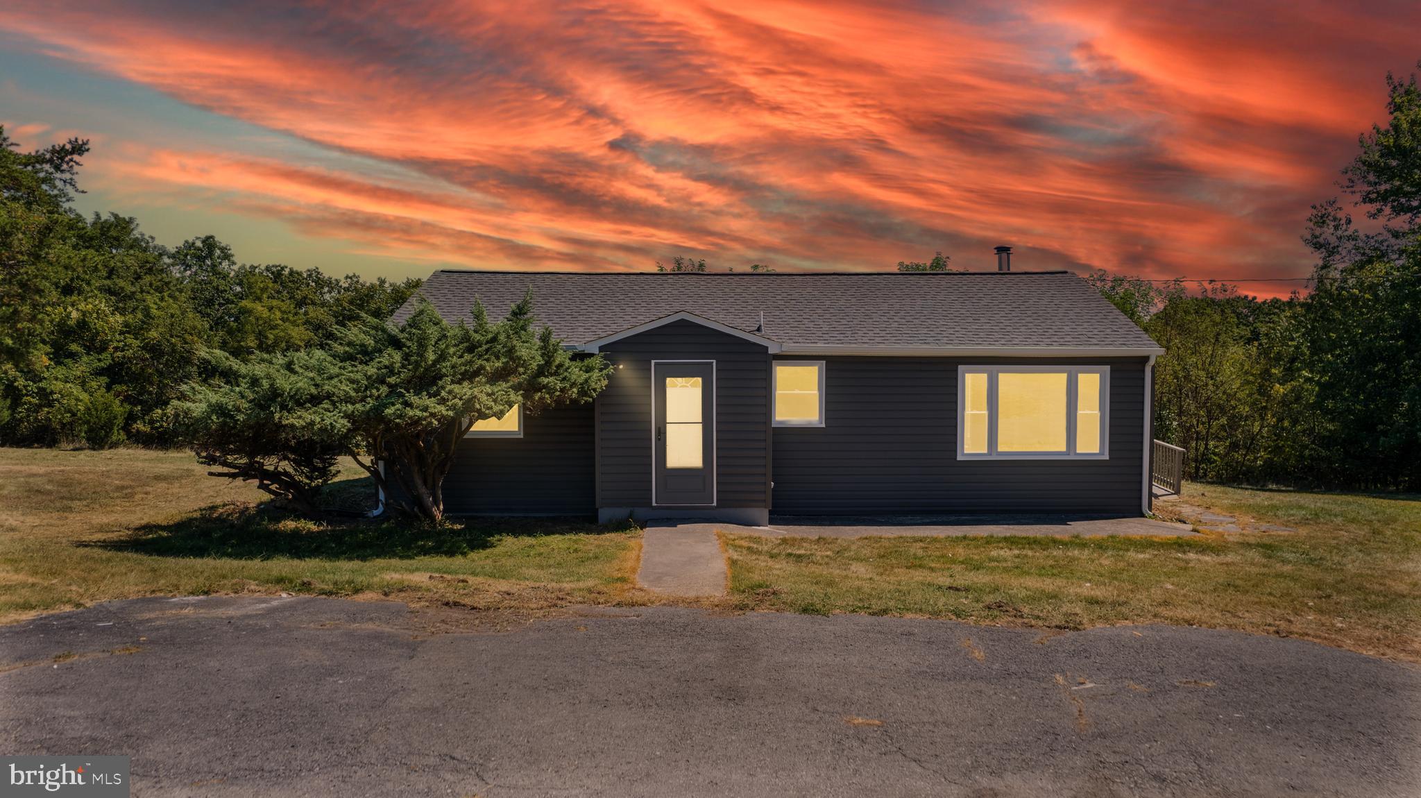 5781 Timber Ridge Road Berkeley Springs, WV 25411 - Photo 2 of 25 a front view of a house with a yard