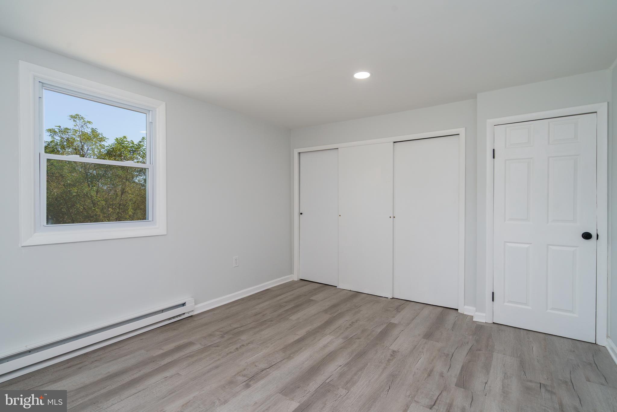 5781 Timber Ridge Road Berkeley Springs, WV 25411 - Photo 22 of 25 a view of an empty room with wooden floor and a window