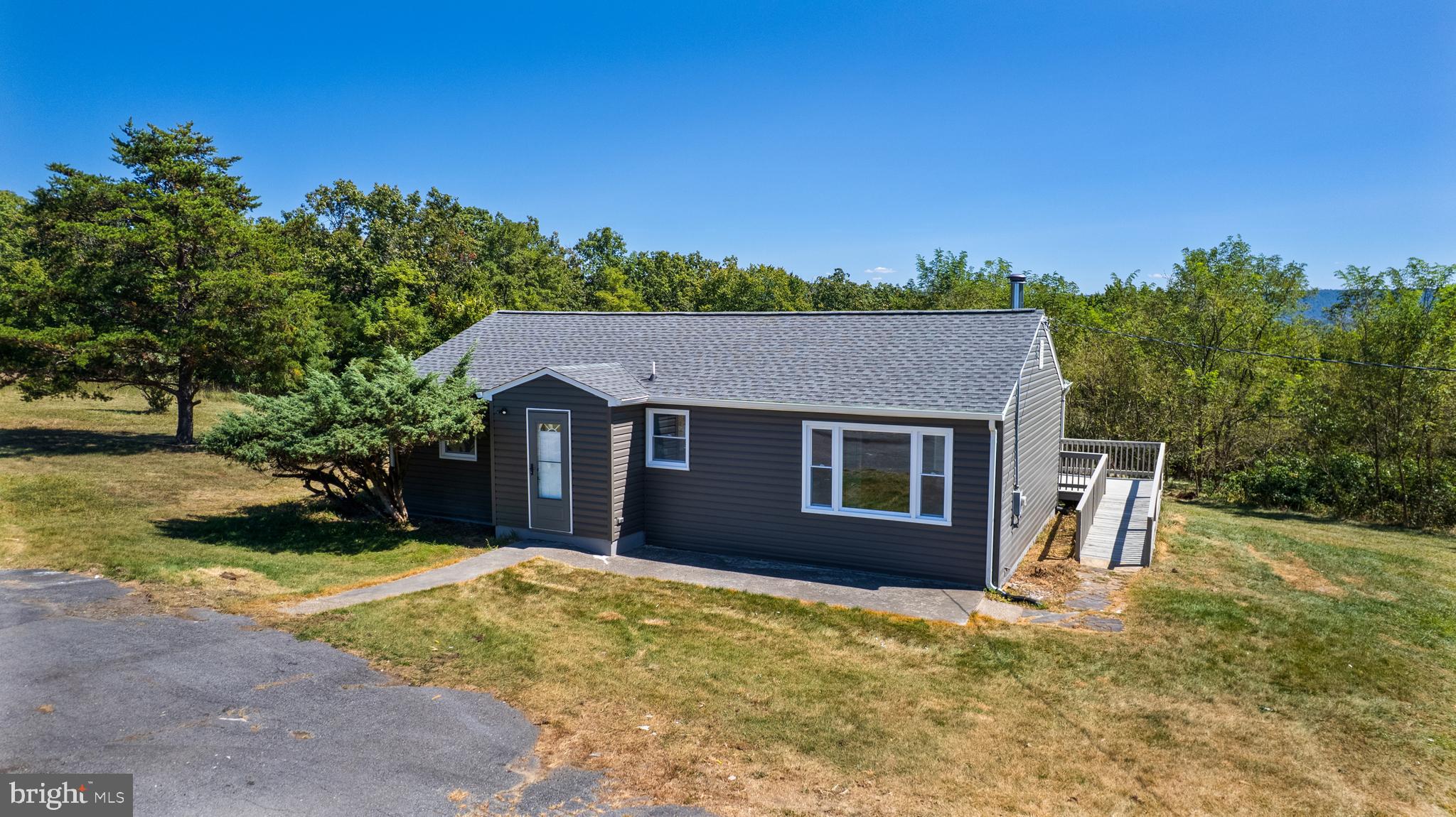 5781 Timber Ridge Road Berkeley Springs, WV 25411 - Photo 4 of 25 front view of a house with a yard