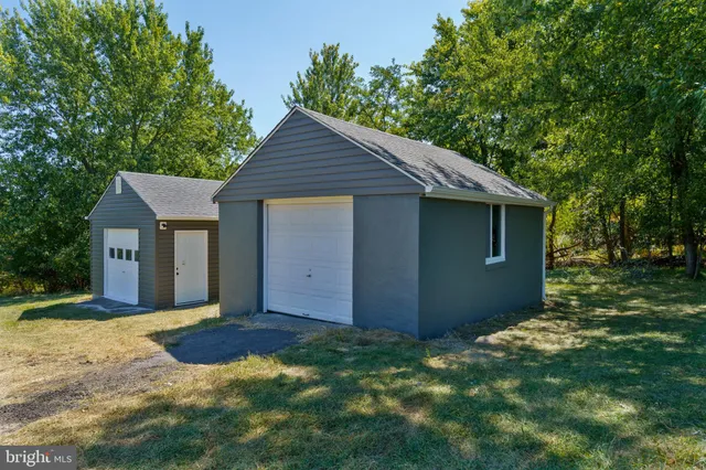 a view of house with backyard space and garden