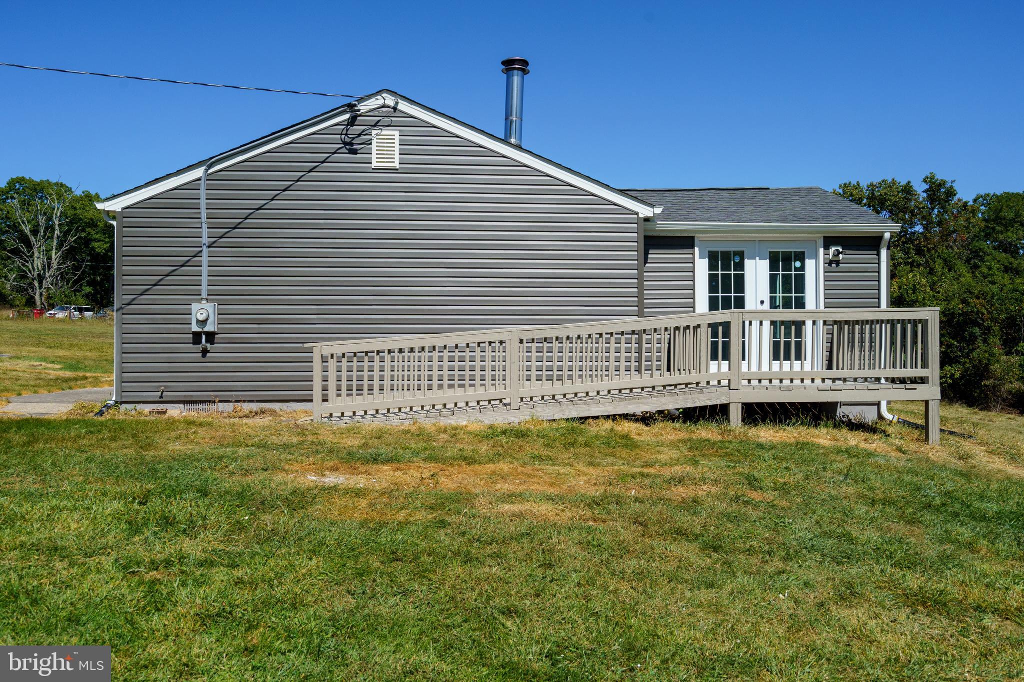 5781 Timber Ridge Road Berkeley Springs, WV 25411 - Photo 10 of 25 a front view of a house with a garden