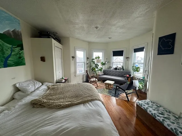 a bedroom with a bed window and couch