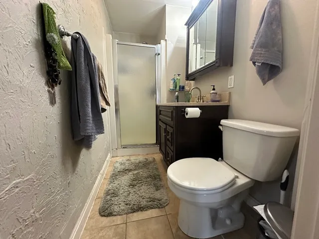 a white toilet sitting next to a bathroom sink and a mirror