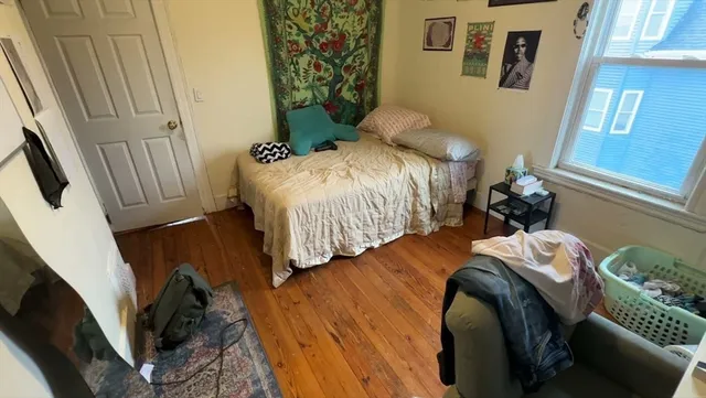 a bedroom with a bed and a mirror