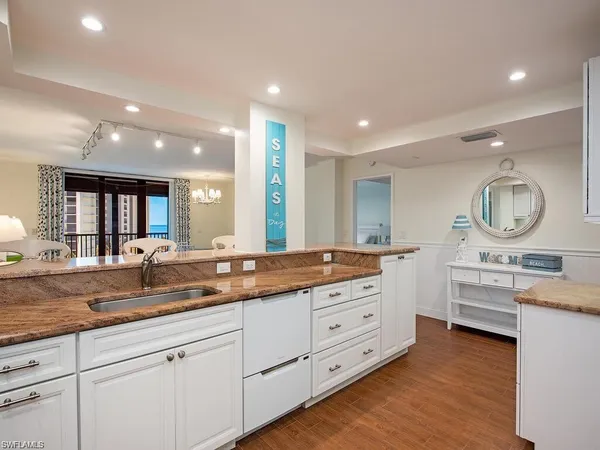 a bathroom with a granite countertop double vanity sink and a mirror