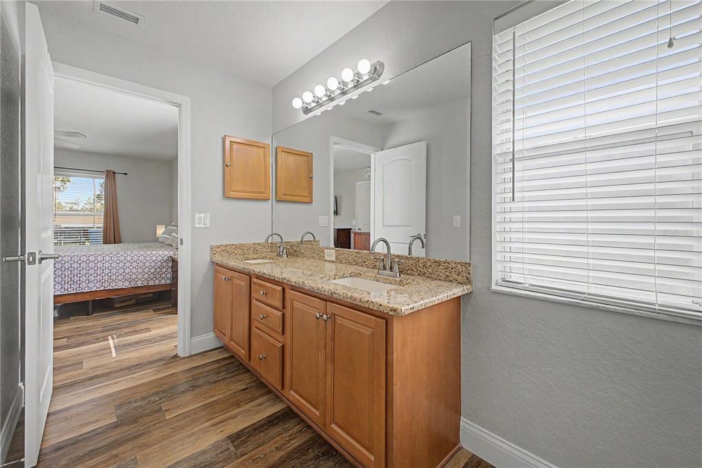 11213 Flock Avenue Weeki Wachee, FL 34613 - Photo 26 of 46 a bathroom with a sink and a mirror