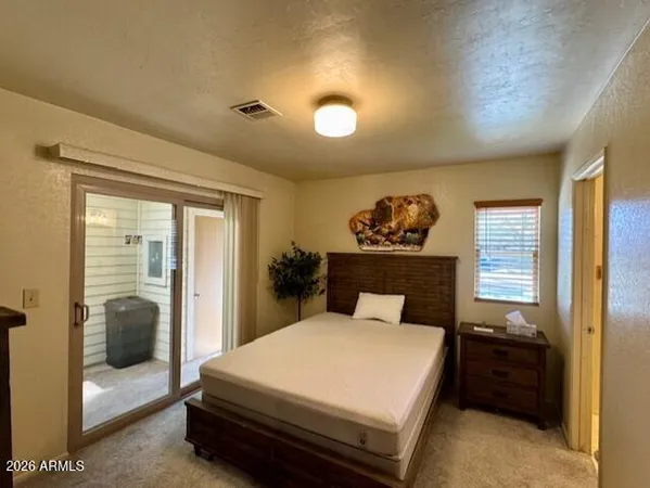 a bed sitting in a bedroom and a table