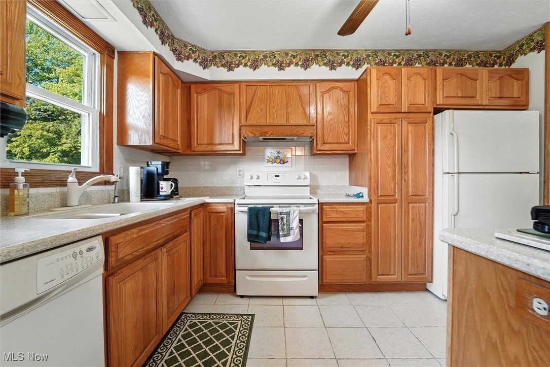 15744 Rock Creek Road Thompson, OH 44086 - Photo 18 of 38 Kitchen with oak cabinets and plenty of counter space