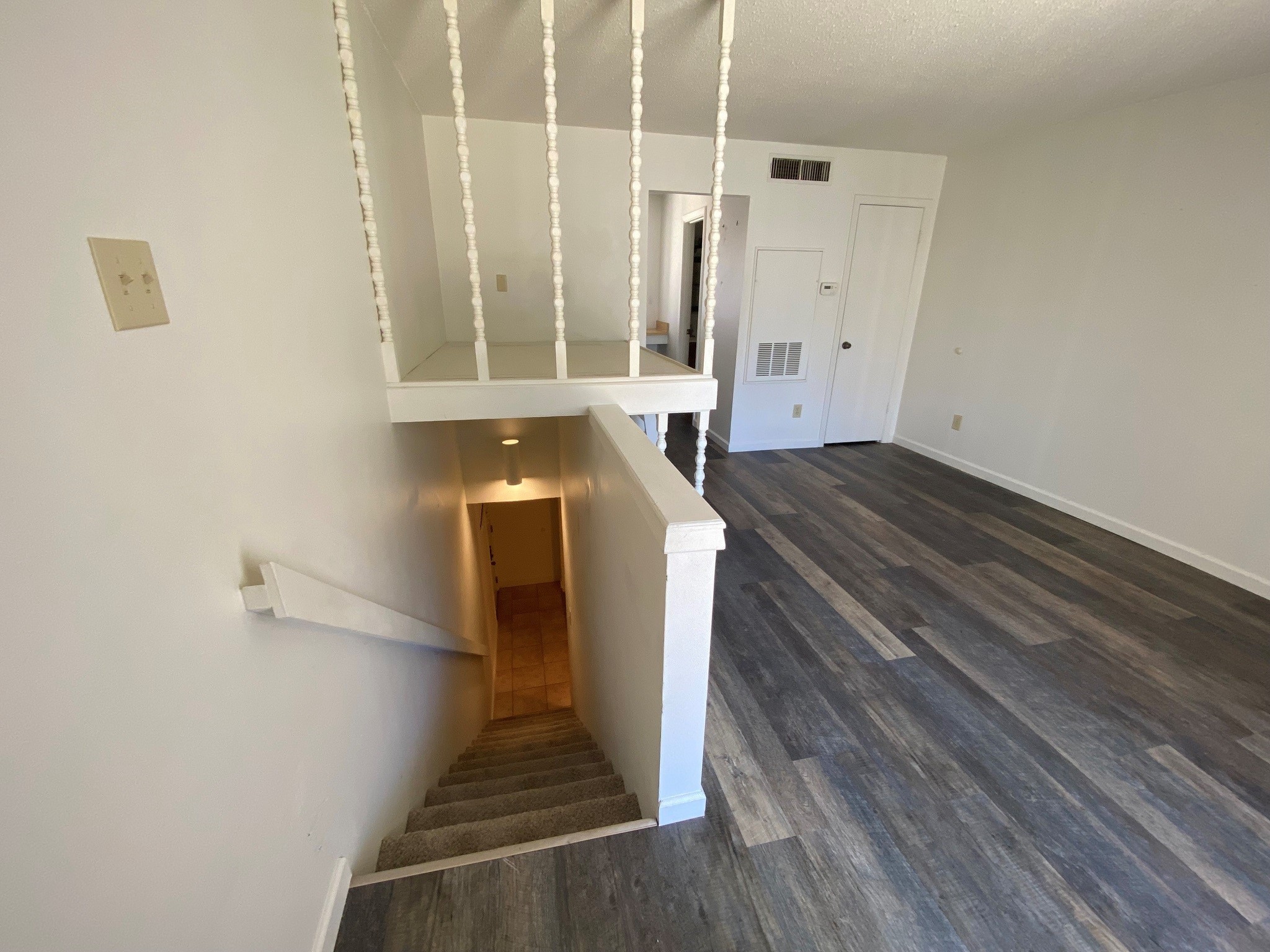 501 Bass Boat Village, Unit 106 Point Blank, TX 77364 - Photo 4 of 7 a view of a hallway with wooden floor and staircase