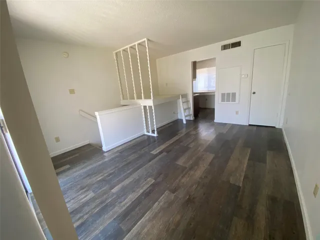 wooden floor in an empty room with a fireplace
