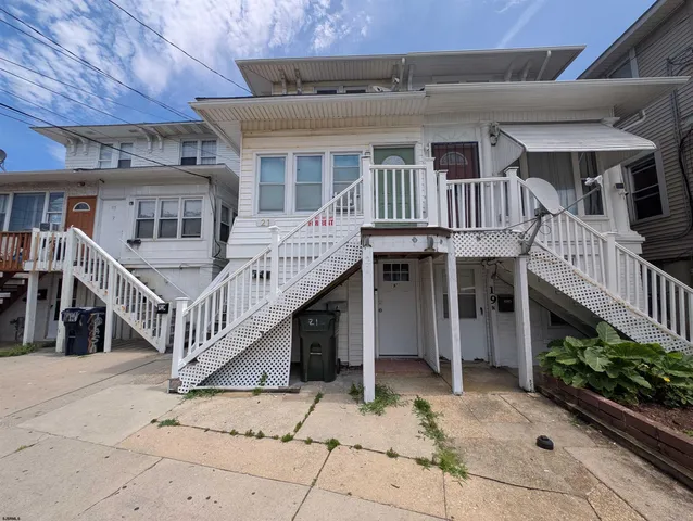 a view of house with deck and wooden floor