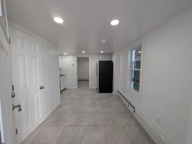 a kitchen with a refrigerator and a stove top oven
