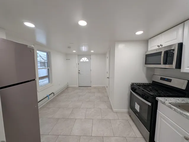 a kitchen with sink cabinets and stainless steel appliances
