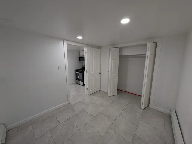 a bathroom with a sink a glass door shower and toilet