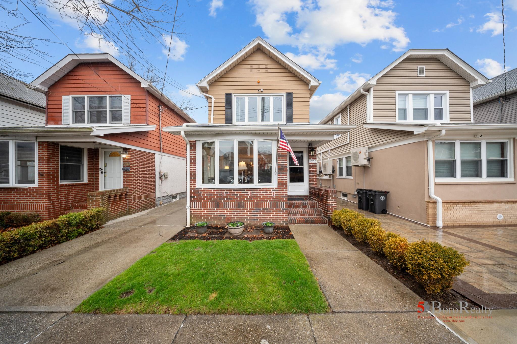 Traditional-style home featuring brick siding