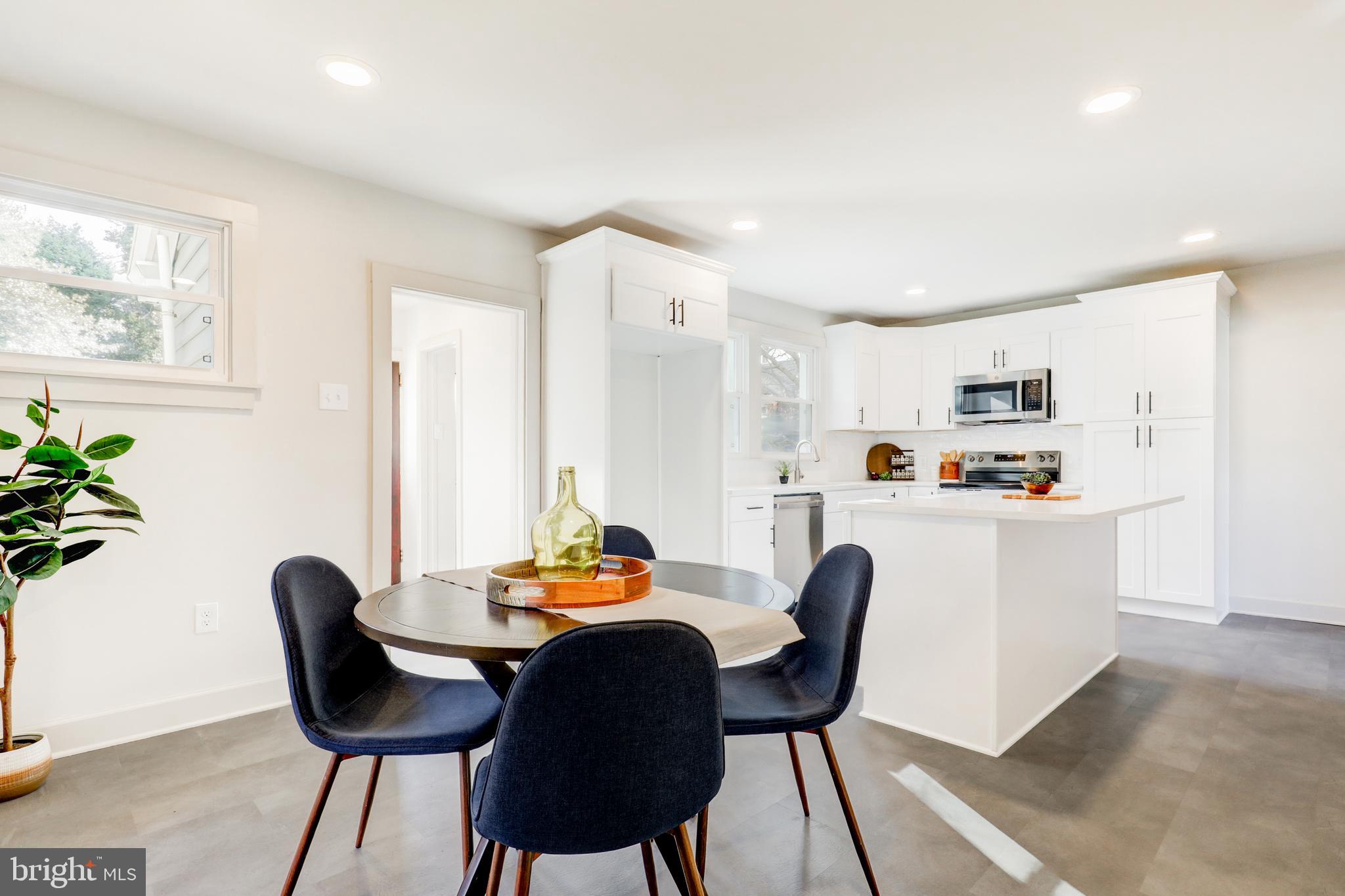 1081 Wynnwood Road Abington, PA 19001 - Photo 8 of 45 a living room with furniture a dining table chairs kitchen view and wooden floor