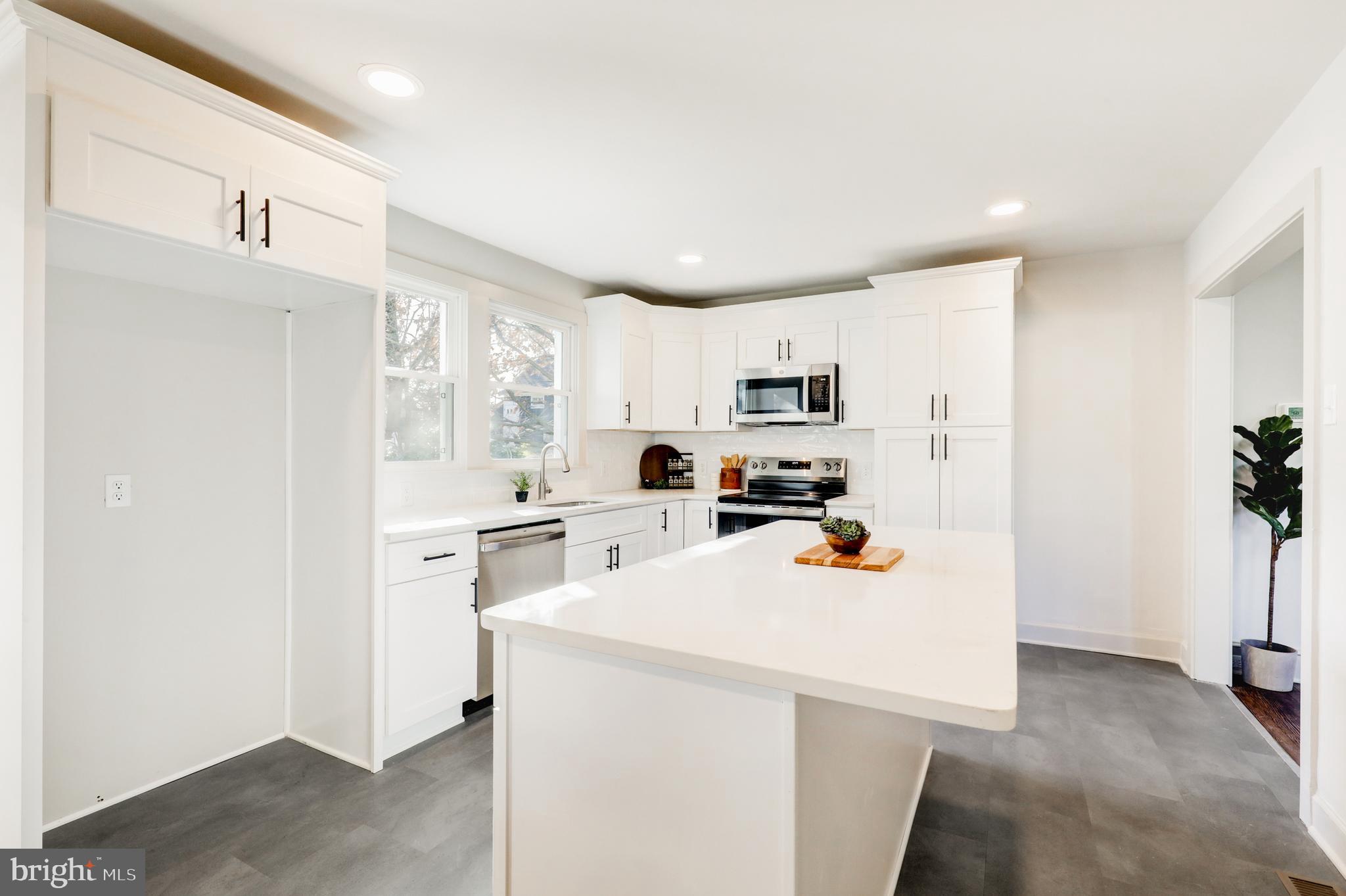 1081 Wynnwood Road Abington, PA 19001 - Photo 10 of 45 a kitchen view with stainless steel appliances a stove a sink a refrigerator a window