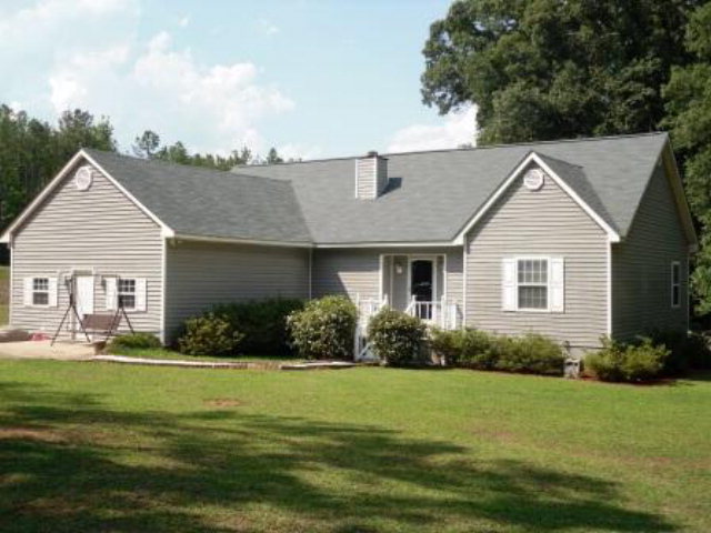 1788 Reedy Creek Road Forsyth, GA 31029 - Photo 1 of 1 a front view of a house with a yard and garage