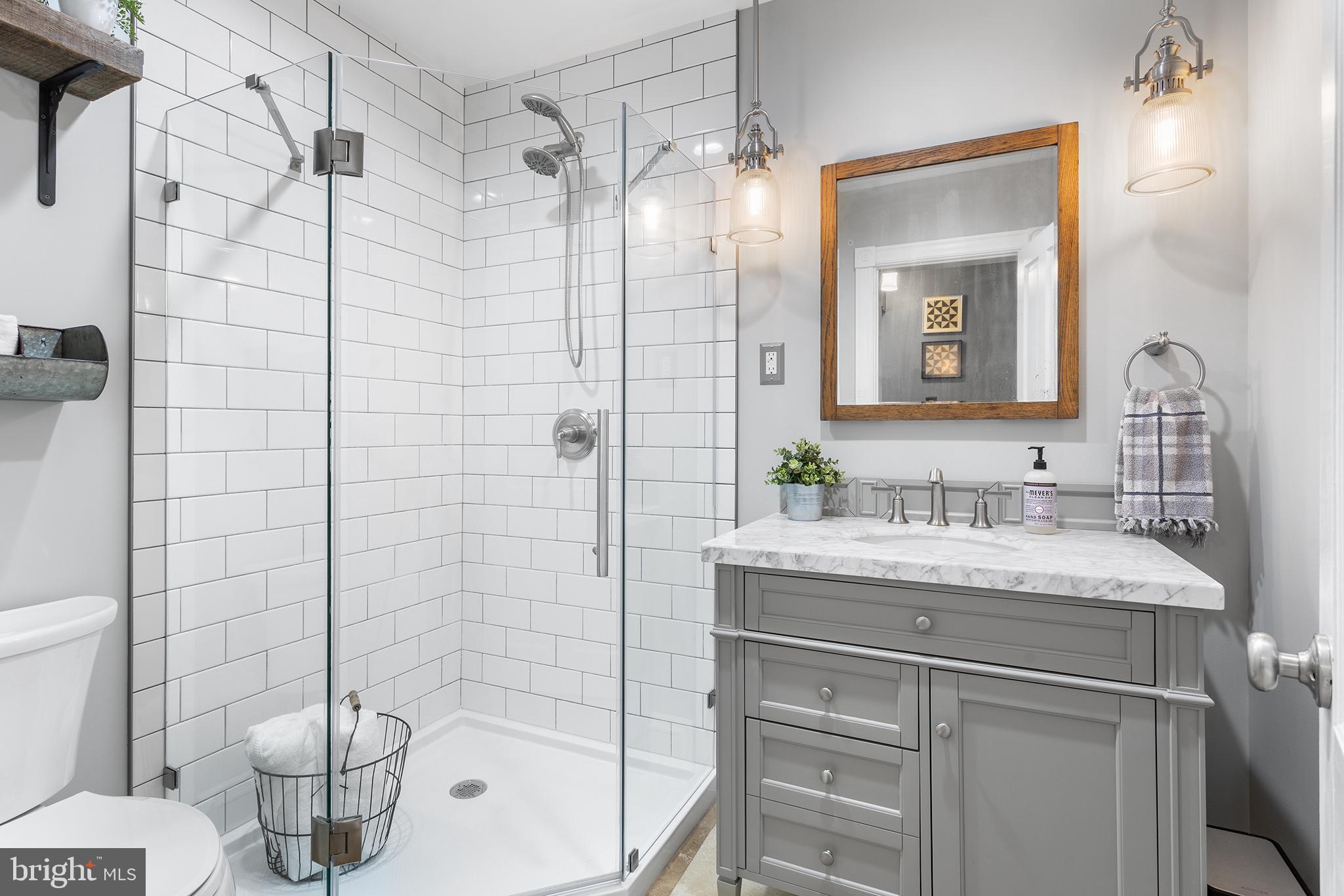 960 Lawrence Road Lawrenceville, NJ 08648 - Photo 34 of 62 a bathroom with a granite countertop sink a toilet and shower