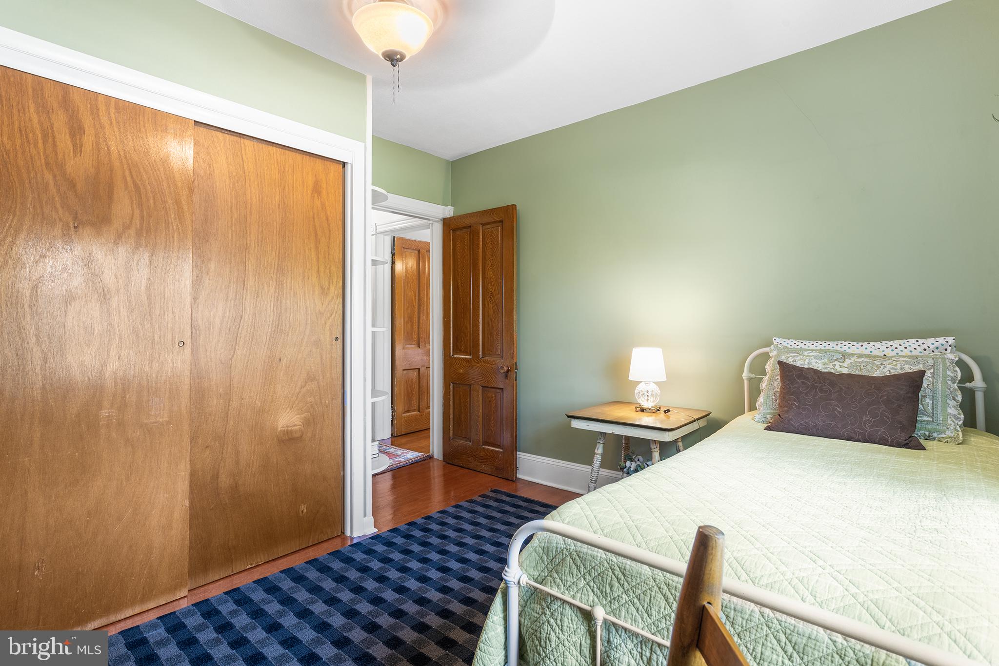 960 Lawrence Road Lawrenceville, NJ 08648 - Photo 36 of 62 a bedroom with a bed and wooden floor