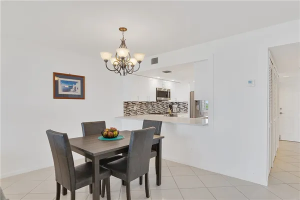 a view of a dining room and a kitchen island with furniture