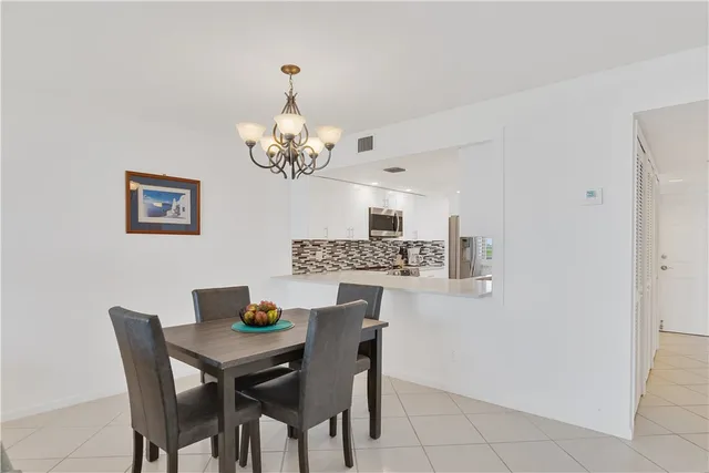 a view of a dining room and a kitchen island with furniture