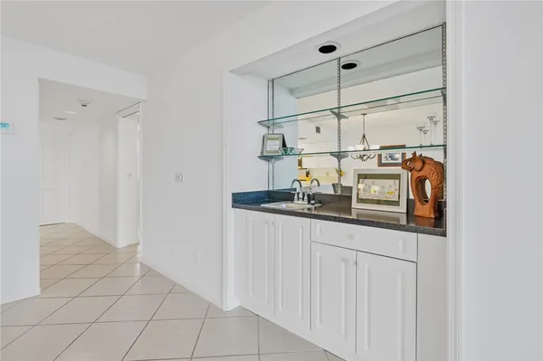 a kitchen with a sink and white cabinets