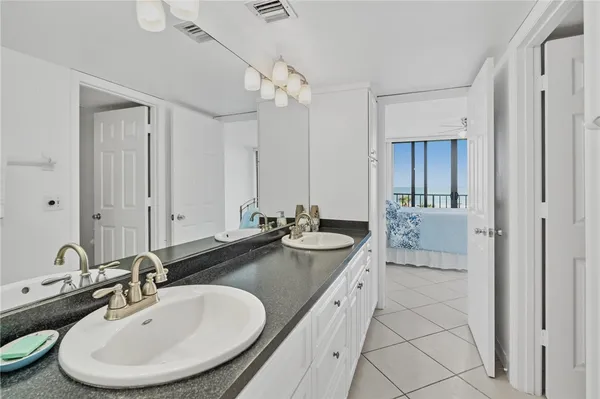 a bathroom with a sink a mirror and a shower