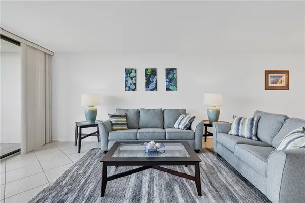 a view of a city from a balcony with furniture