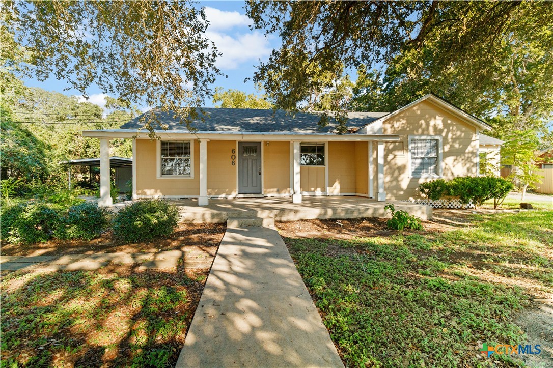 a front view of a house with yard patio and green space
