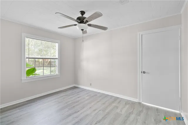 wooden floor in an empty room with a window