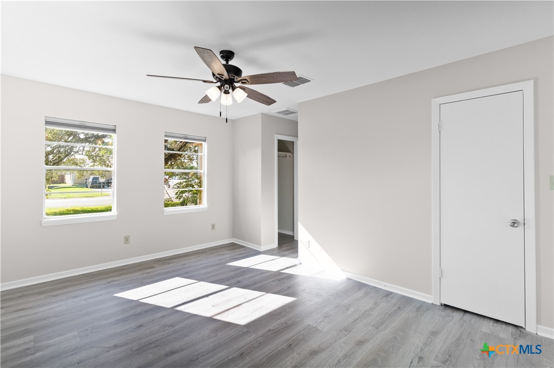 606 West Gayle Street Edna, TX 77957 - Photo 16 of 20 a view of an empty room with window and wooden floor