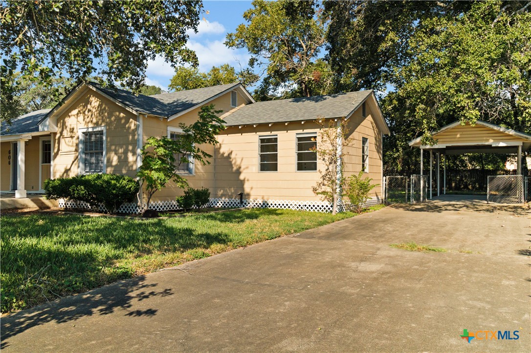 606 West Gayle Street Edna, TX 77957 - Photo 3 of 20 a front view of a house with a yard and garage